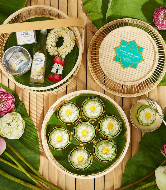 Thai Songkran gift set with lotus-shaped kanom ar-lua desserts, scented water, and fragrant potpourri on bamboo trays