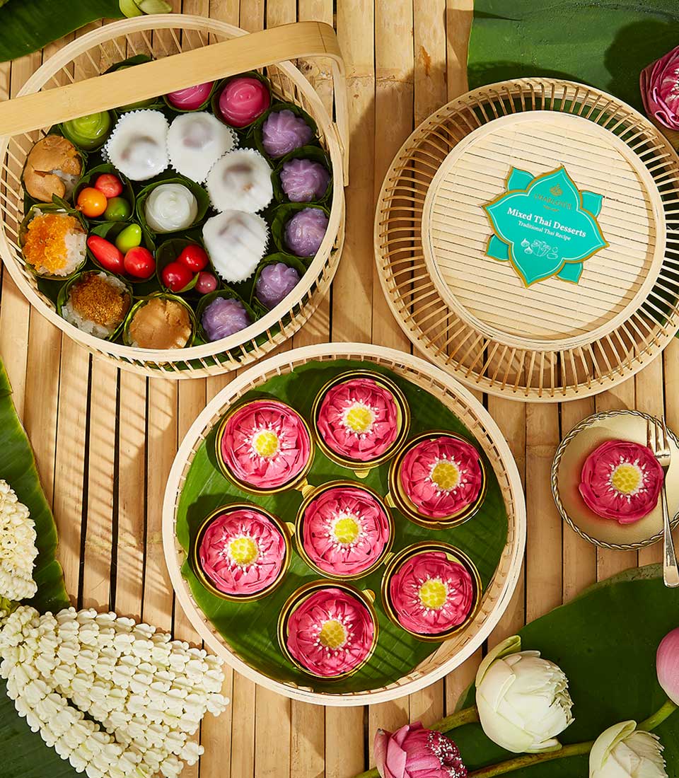 Traditional Thai sweets gift set with lotus-shaped desserts, banana leaf wrapping, and Songkran celebration packaging