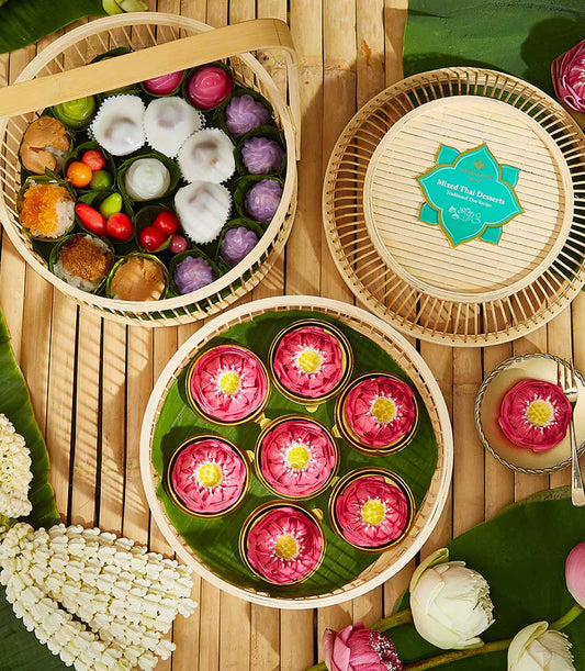 Traditional Thai sweets gift set with lotus-shaped desserts, banana leaf wrapping, and Songkran celebration packaging