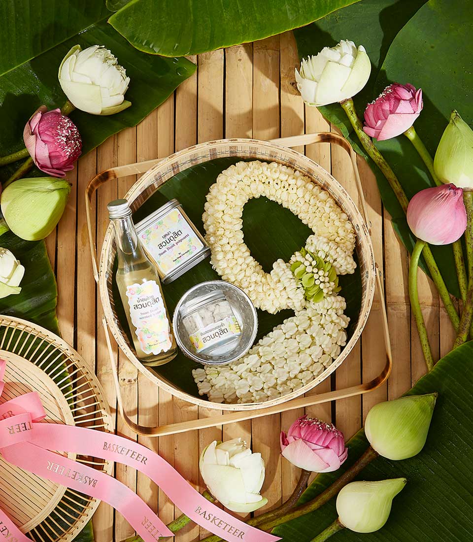 Thai jasmine garland gift set with lotus flowers and aromatics on bamboo mat for Songkran
