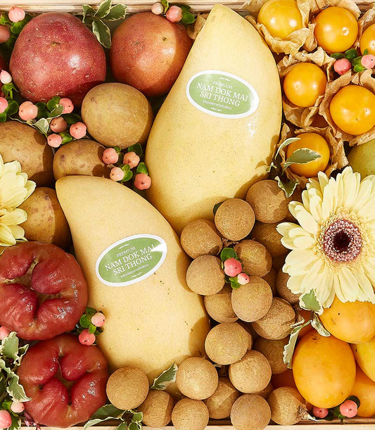 Tropical Harvest gift basket with Nam Dok Mai mangoes, rose apples, longans, physalis, and gerbera daisies in wooden crate