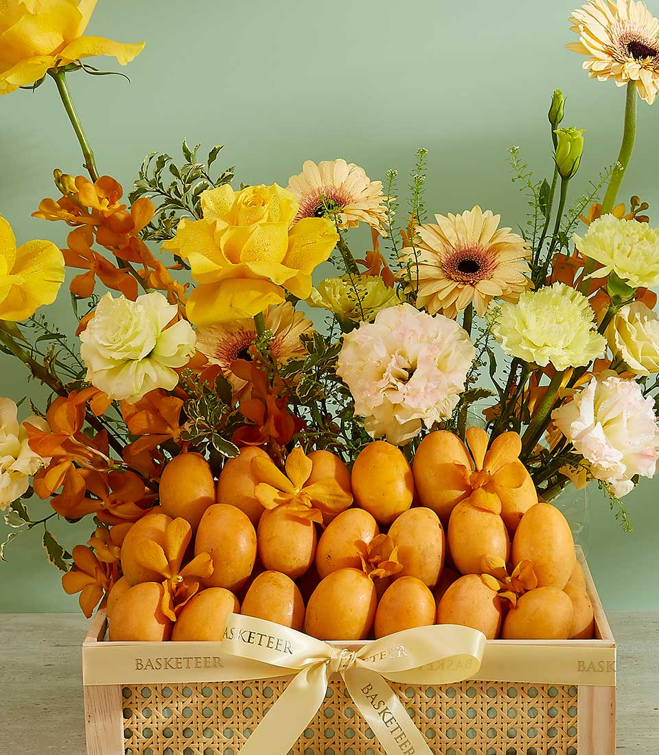 Premium tropical mango crate with yellow roses, gerbera daisies, and orchids in light wood gift box