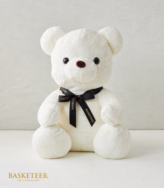 Soft white plush teddy bear with black satin ribbon bow, perfect for gift hampers