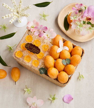 Woven gift basket with Marian plums, Thai dessert sweets, orchids, and seasonal blooms