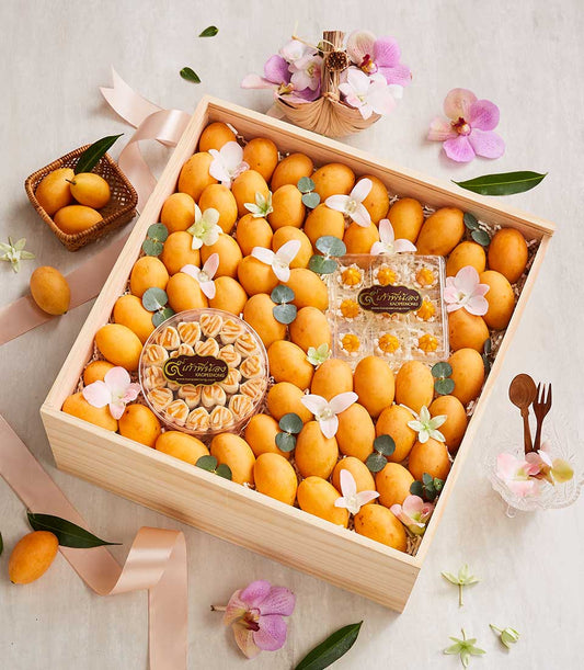 Golden Marian plums with Thai desserts and orchid blossoms in luxury gift hamper