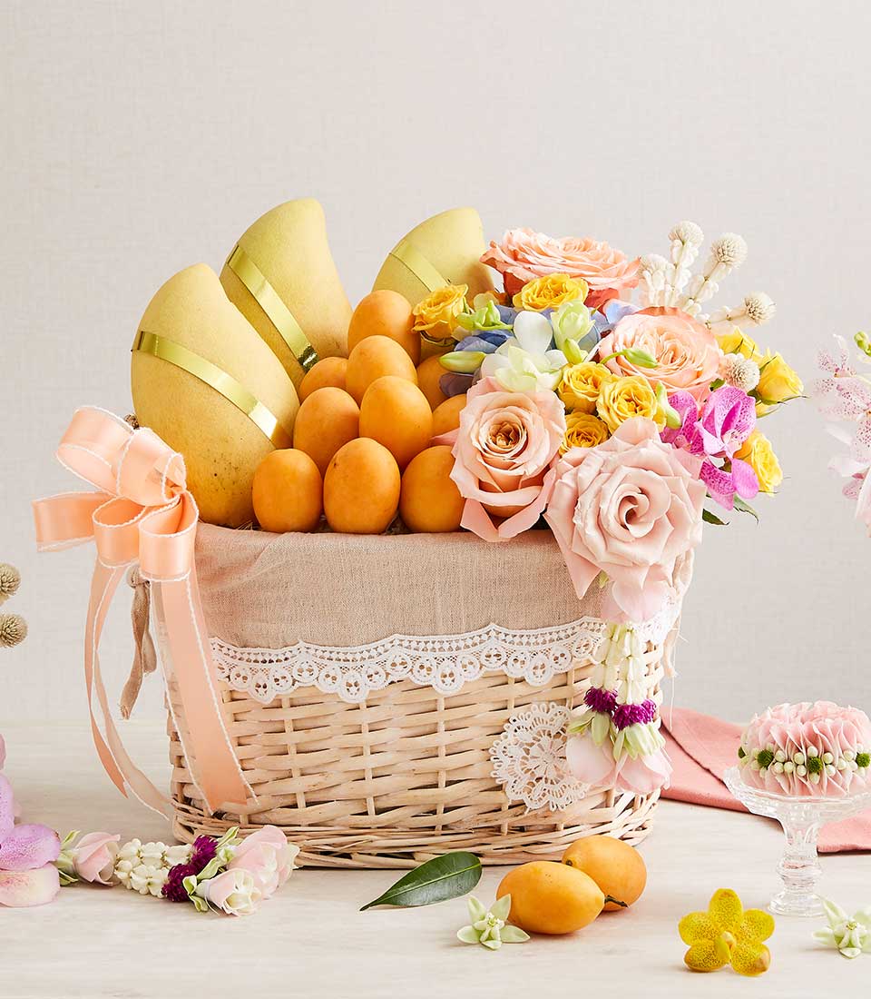 Premium fruit and flower gift basket with golden mangoes, fresh roses, hydrangeas, and orchids for Thai New Year celebrations