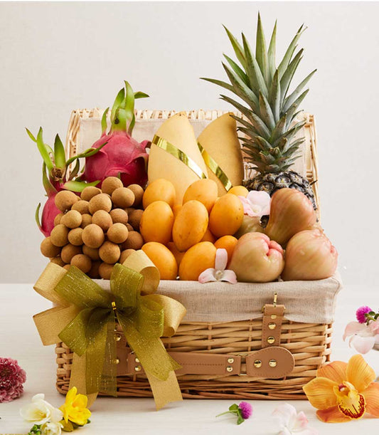 Premium wicker hamper filled with fresh Thai tropical fruits, golden mangoes, dragon fruit, and seasonal produce with gold