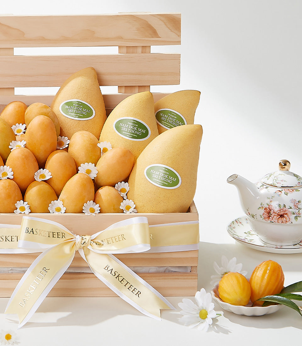 Premium Nam Dok Mai and Mayongchid mango gift crate with cream ribbon and fresh daisies