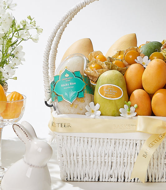 Exotic tropical fruit gift basket with mangoes, golden berries, and sticky rice dessert