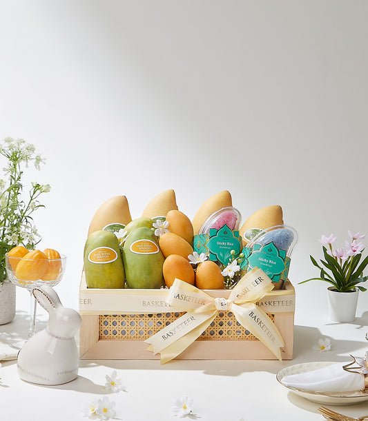 Luxury tropical fruit gift basket with ripe mangoes, sticky rice, and artisan presentation in wooden box