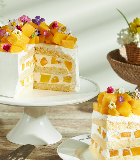 Super soft fresh cream mango cake with tropical fruit layers and edible flowers, Charlotte Bakery artisan celebration cake