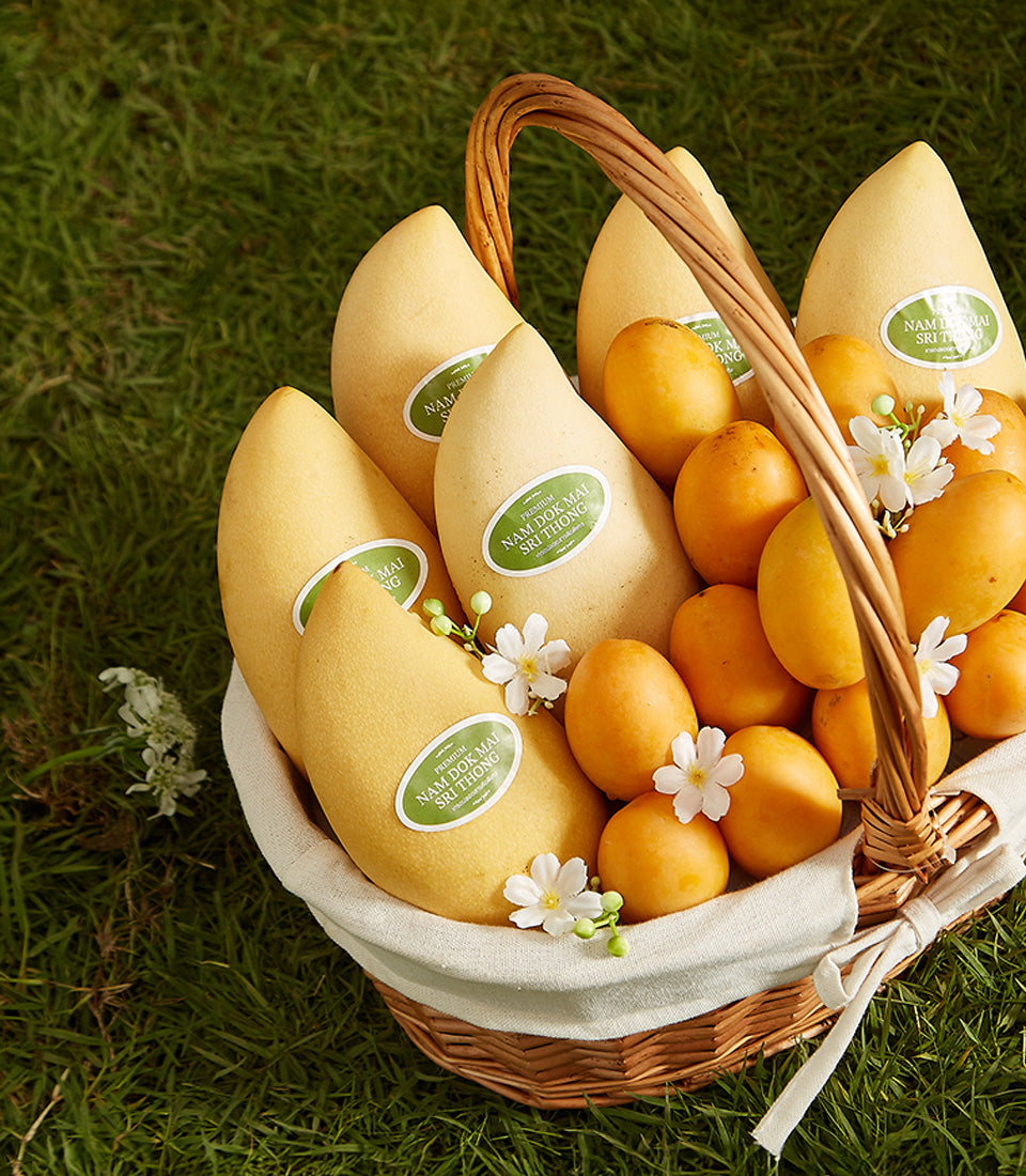 Premium Nam Doc Mai mangoes and white orchids in woven basket gift hamper