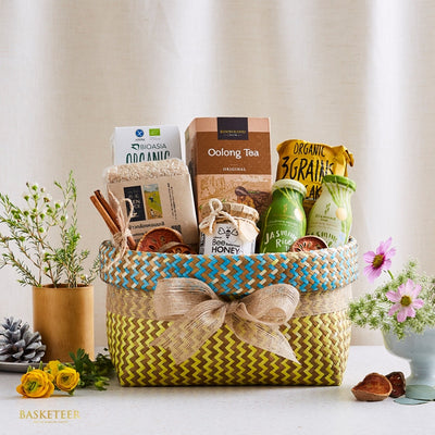 Woven gift basket with organic tea, honey, rice, and wellness foods for health-conscious gifting