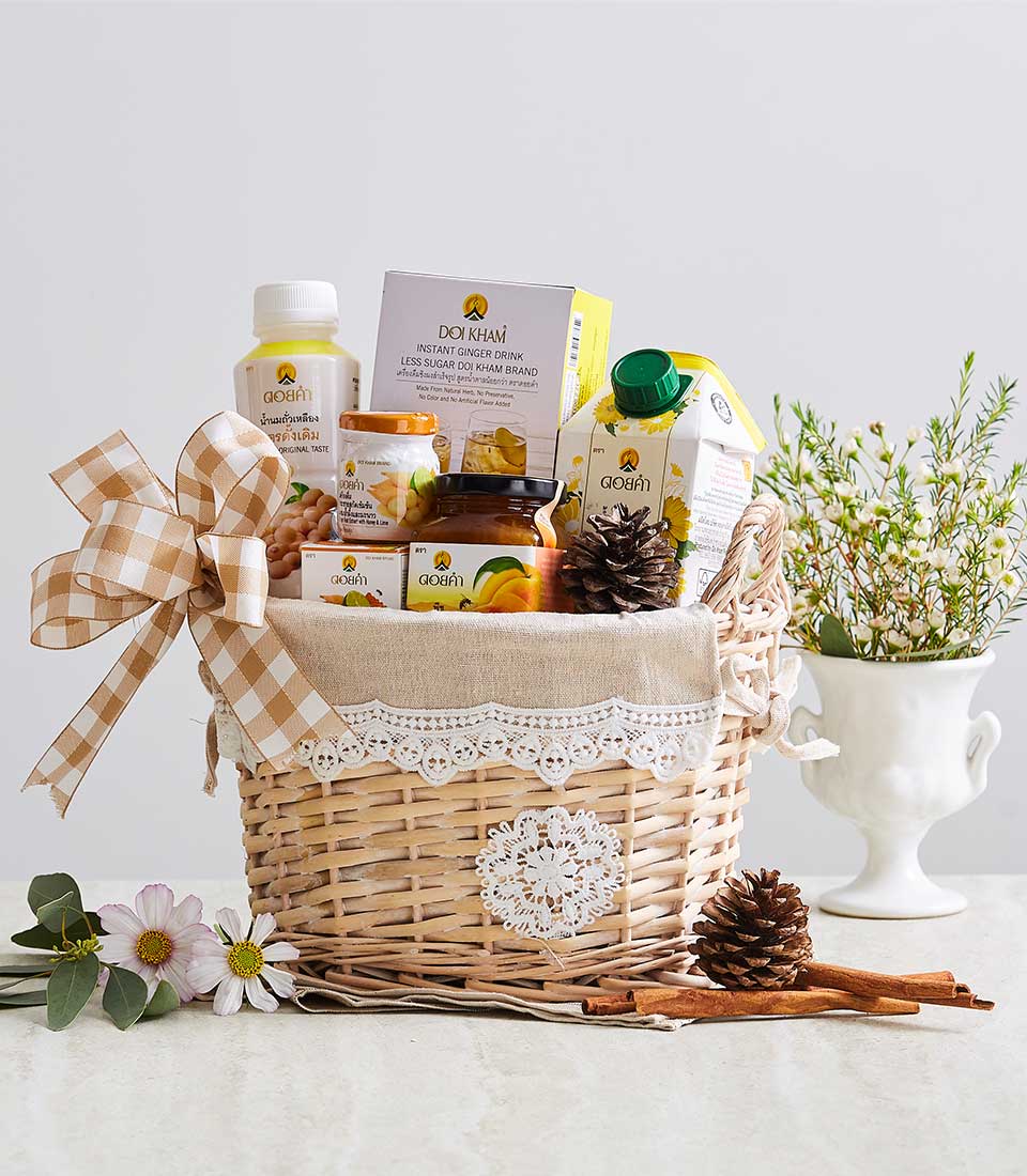 Highland Doi Kham wicker gift basket with gourmet preserves, ginger drink, and artisan food selections, adorned with beige