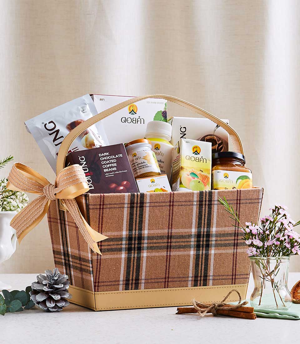 Brown plaid gift basket with gold ribbon bow filled with Doi Tung and Doi Kham gourmet products, honey, and coffee beans