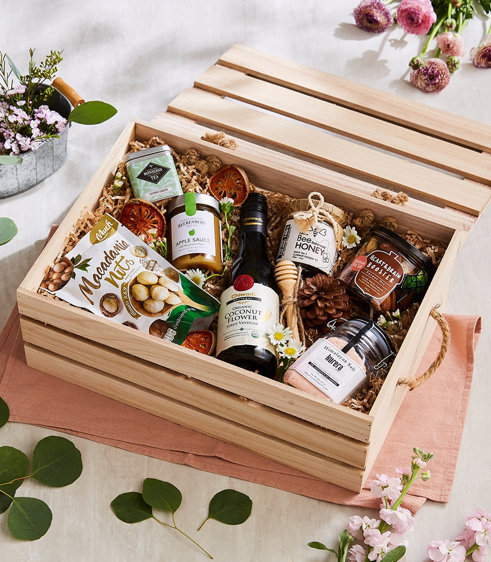 Wooden crate gift hamper with gourmet health foods, macadamia nuts, honey, green tea, and organic condiments
