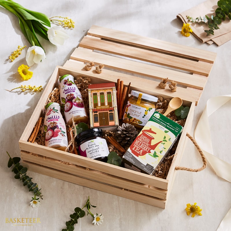 Wooden crate gift set with Thai fruit juices, peanut butter, mulberry jam, and organic tea