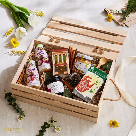 Wooden crate gift set with Thai fruit juices, peanut butter, mulberry jam, and organic tea