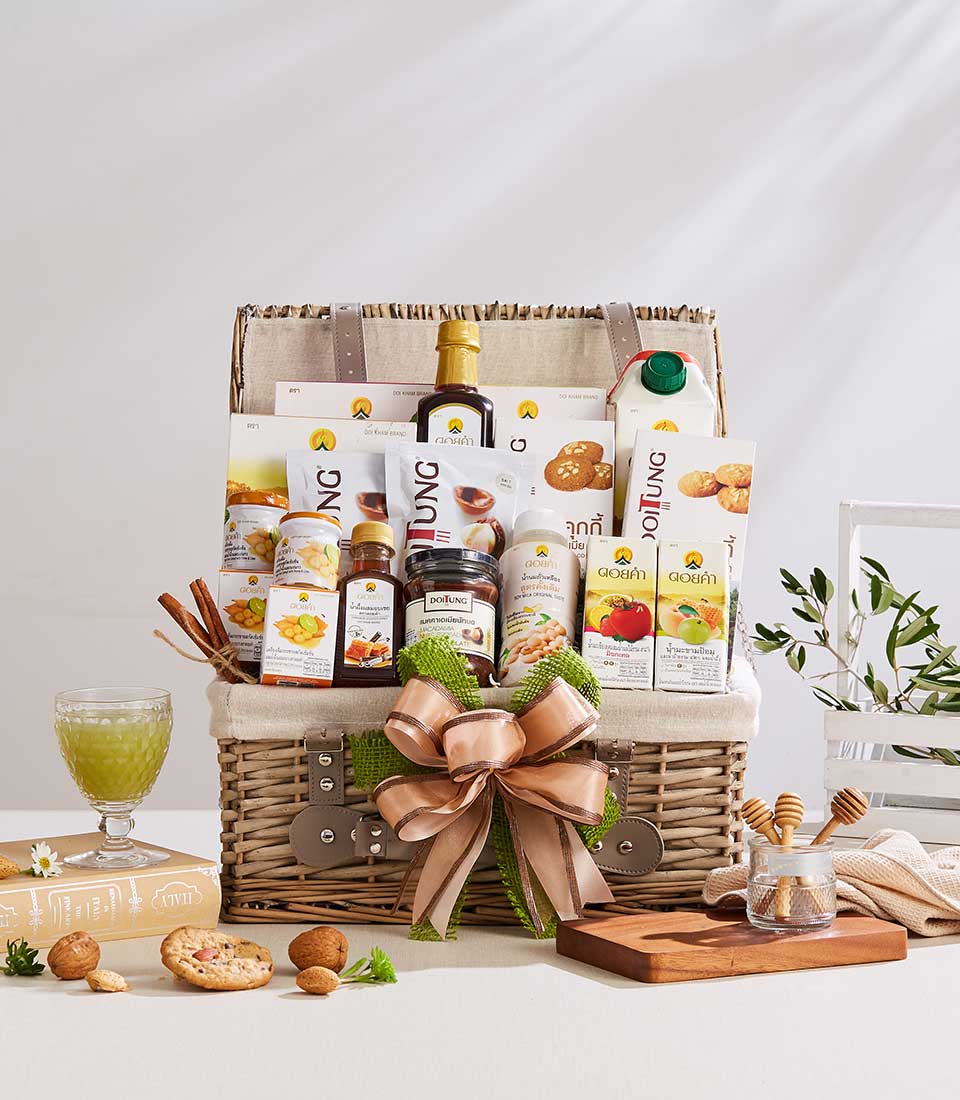 Premium wicker gift basket with Doi Tung and Doi Kham wellness products, peach ribbon, and artisan gourmet selection