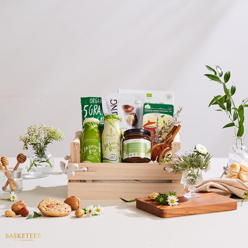 Thai organic gift basket with jasmine rice, coconut nectar, grains and tea in wooden crate