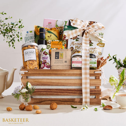 Premium Thai gourmet gift basket with organic rice, mangosteen juice, nuts, and artisan condiments in wooden crate