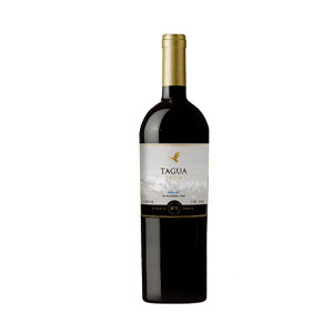 Premium red wine bottle with gold foil capsule in luxury gift basket