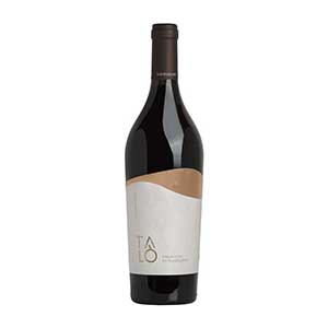 Premium red wine gift with copper-gold label detail, paired with artisan cookies for Christmas celebration