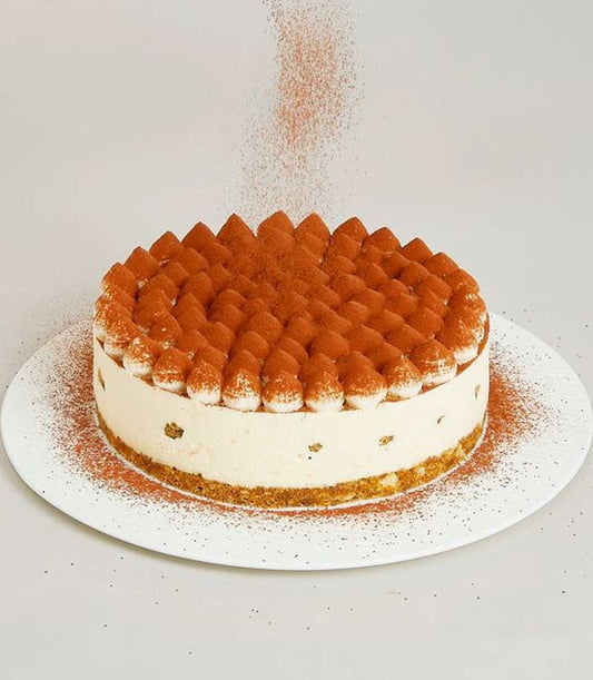 Tiramisu mascarpone cake with cocoa-dusted cream dollops and coffee-soaked ladyfingers