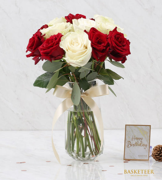 Red and white roses in glass vase with gold ribbon, premium fresh flower arrangement for gifting