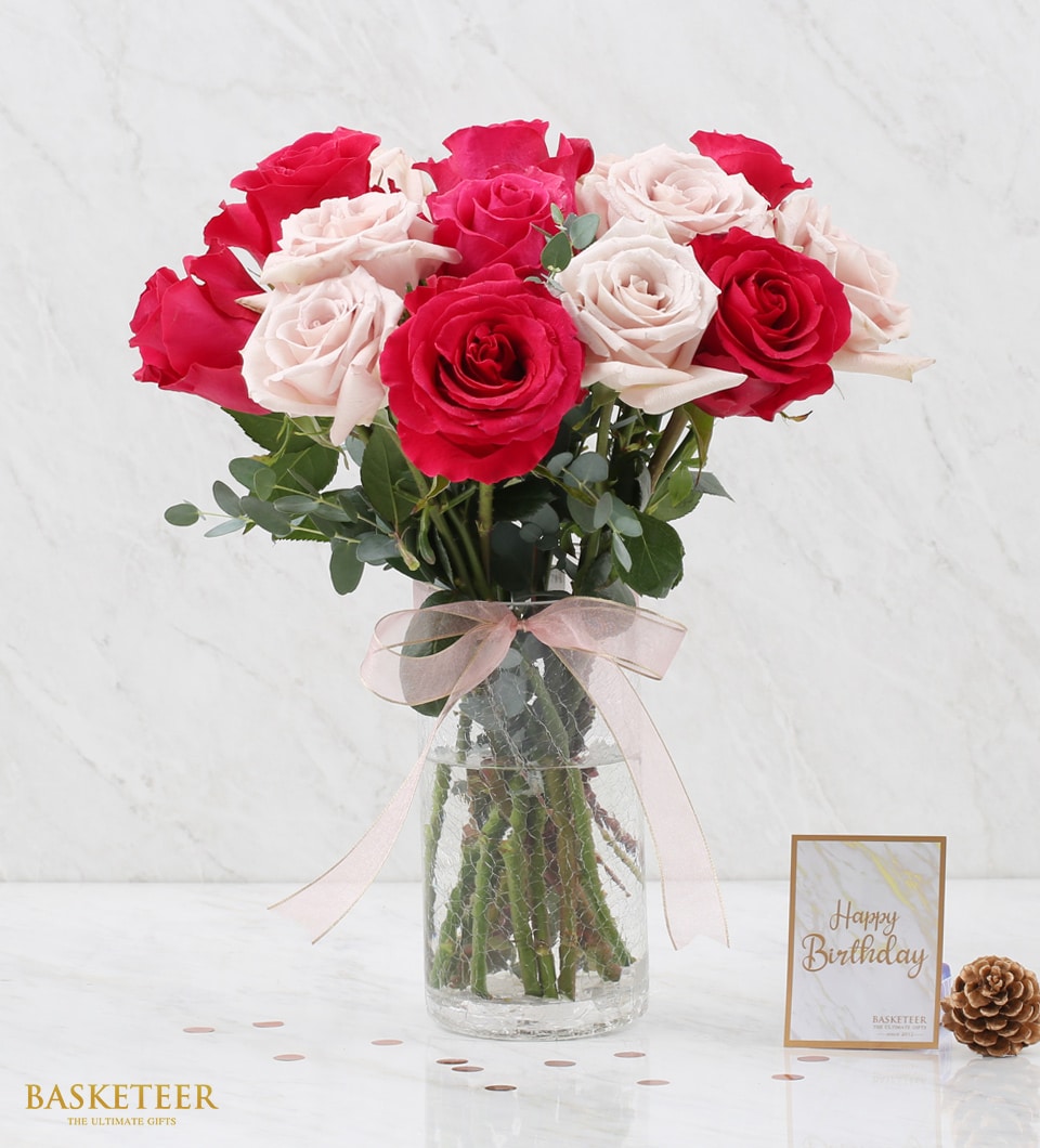 Dark pink and nude rose bouquet in textured glass vase with eucalyptus and pink ribbon