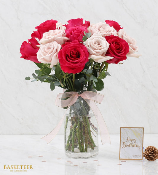 Dark pink and nude rose bouquet in textured glass vase with eucalyptus and pink ribbon