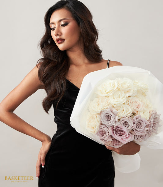 Creamy white and dusty mauve roses wrapped in white paper, romantic anniversary bouquet for her