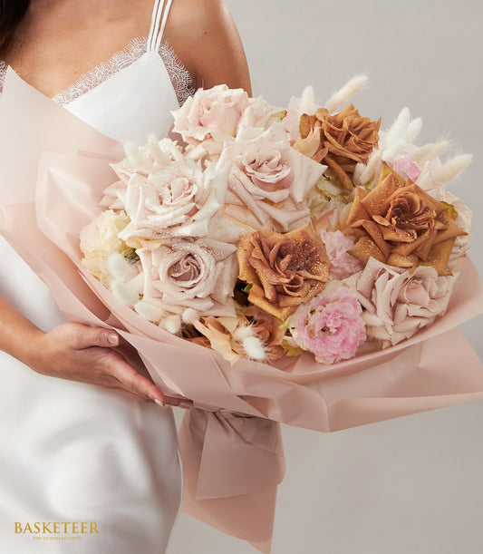 Dusty pink and bronze rose Valentine bouquet with glitter detail, wrapped in soft pink tissue