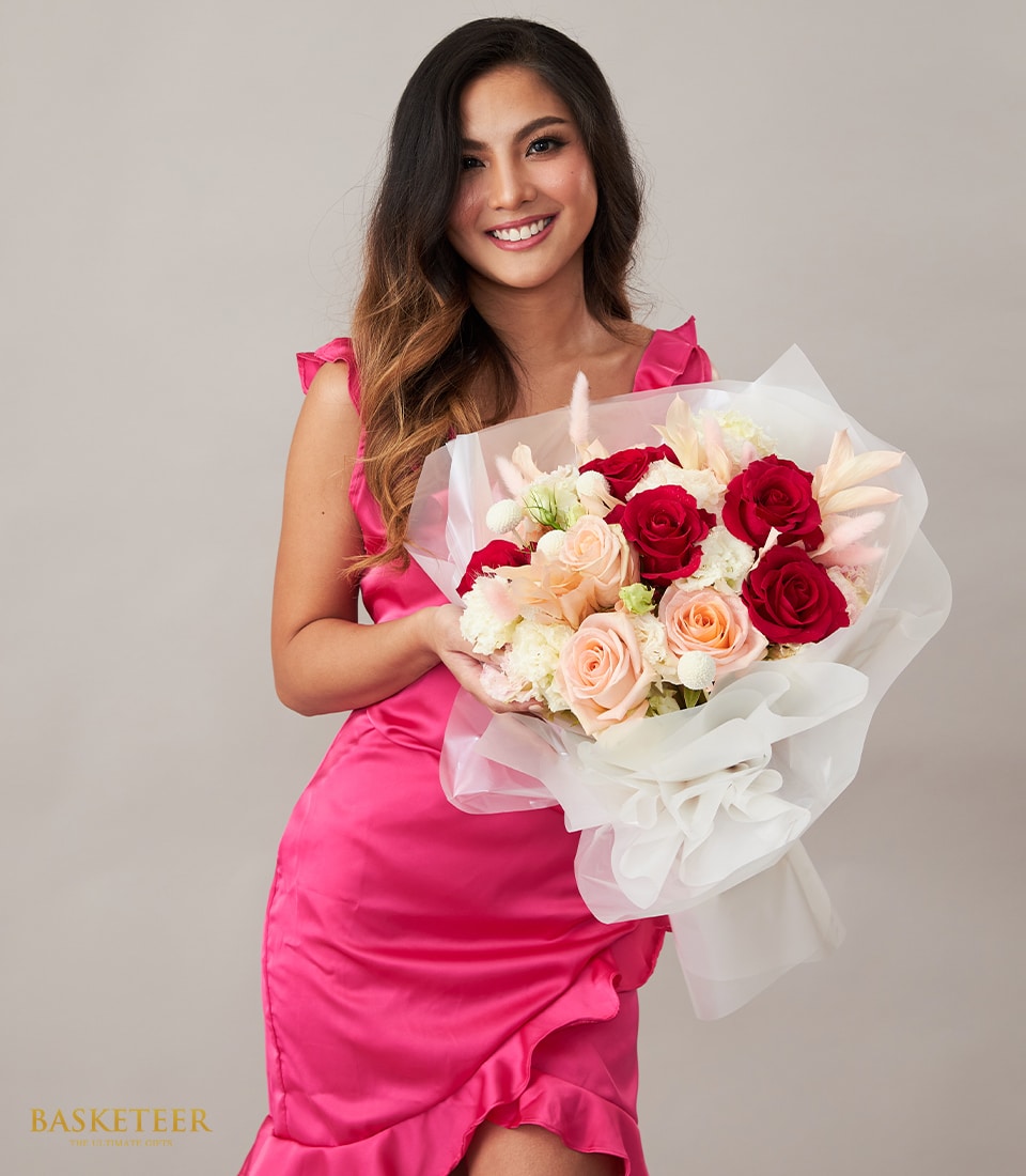 Elegant red and pink rose Valentine's bouquet with white carnations and pampas grass accents
