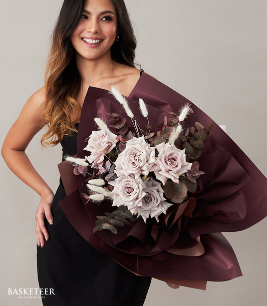 Dusty rose and purple roses bouquet with eucalyptus, Valentine's gift wrapped in burgundy paper