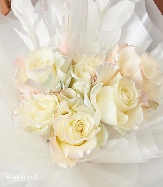 Cream and pale pink roses with white organza wrap and leaf accents, Valentine's Day bouquet