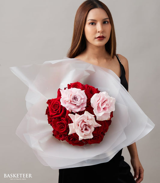 Red and pink rose bouquet with white wrapping, perfect for anniversaries and romantic celebrations
