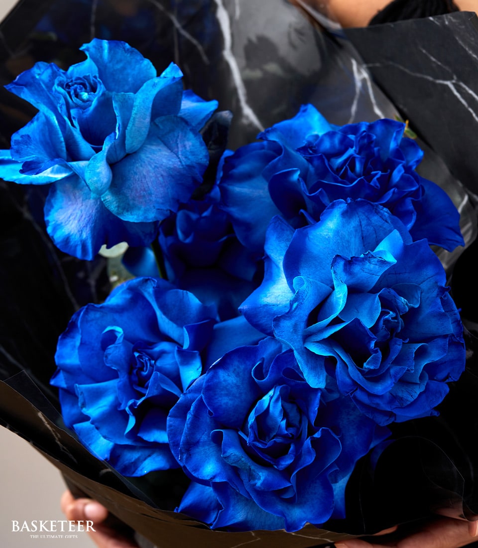 Royal blue rose bouquet with grey marble and black paper wrap, perfect for Valentine's Day or special occasions