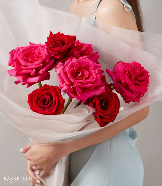 Elegant pink and red rose bouquet in white paper wrapping, perfect Valentine's gift for her