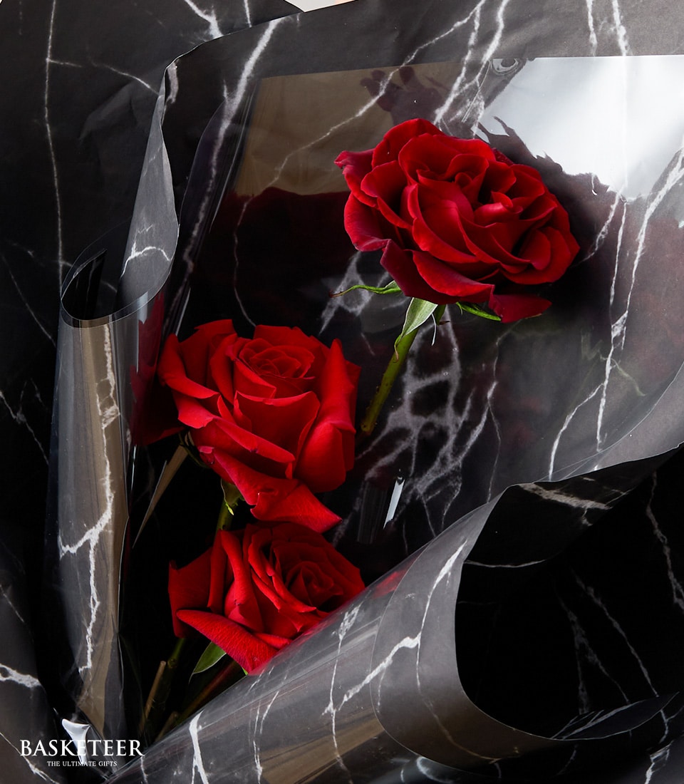 Luxury red rose bouquet with black marble wrap, perfect for anniversaries and romantic occasions