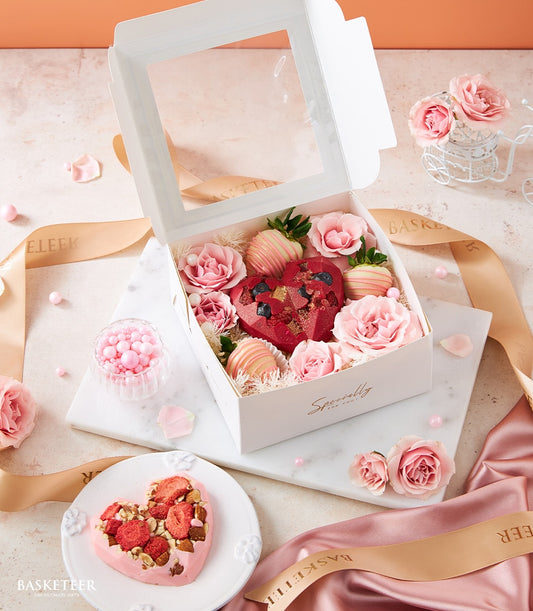 Luxury Valentine's gift box with red geometric chocolate heart, chocolate-dipped strawberries, and pink roses
