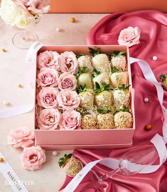 Pink roses and white chocolate-covered strawberries in luxury Valentine's gift box with gold accents