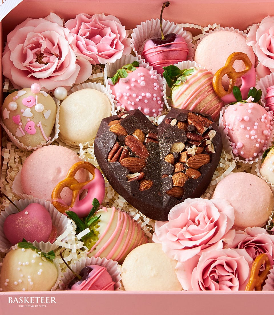 Pink luxury chocolate and strawberry gift box with roses and macarons for Valentine's Day