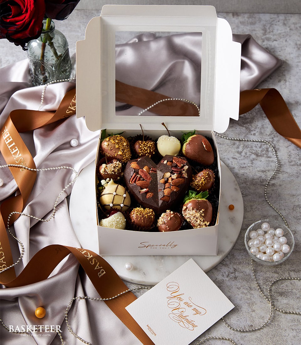 Luxury gift box with chocolate-covered strawberries, heart truffle, and assorted chocolate treats in white, dark, and milk