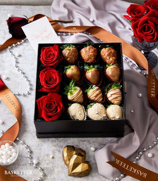 Luxury red roses and chocolate-dipped strawberries in premium gift box for Valentine's Day