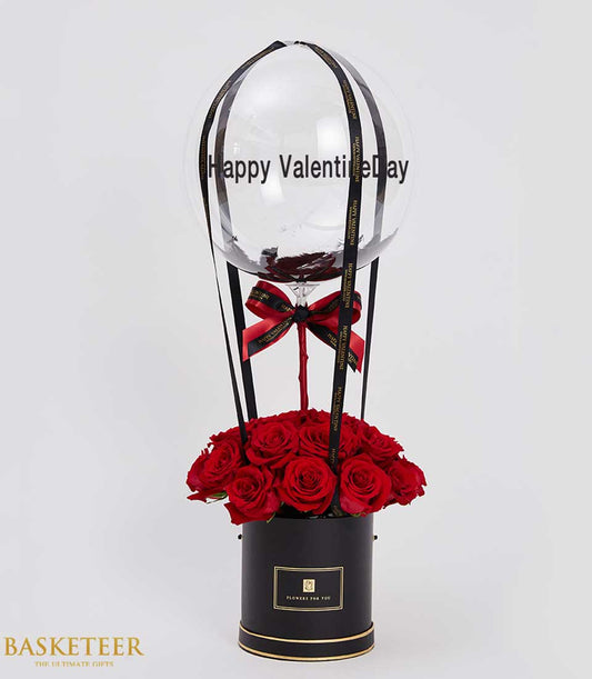 Luxury red rose box with hot air balloon and Happy Valentine's Day greeting, premium gift arrangement