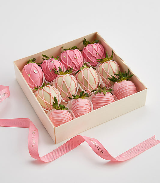 Luxury chocolate-covered strawberries in pink and white with gold accents, artisan Valentine's gift box
