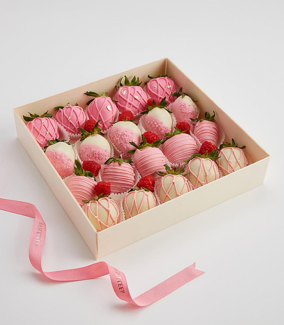 Luxury chocolate-covered strawberries in pink and white with gold leaf, fresh raspberries, Valentine's gift box