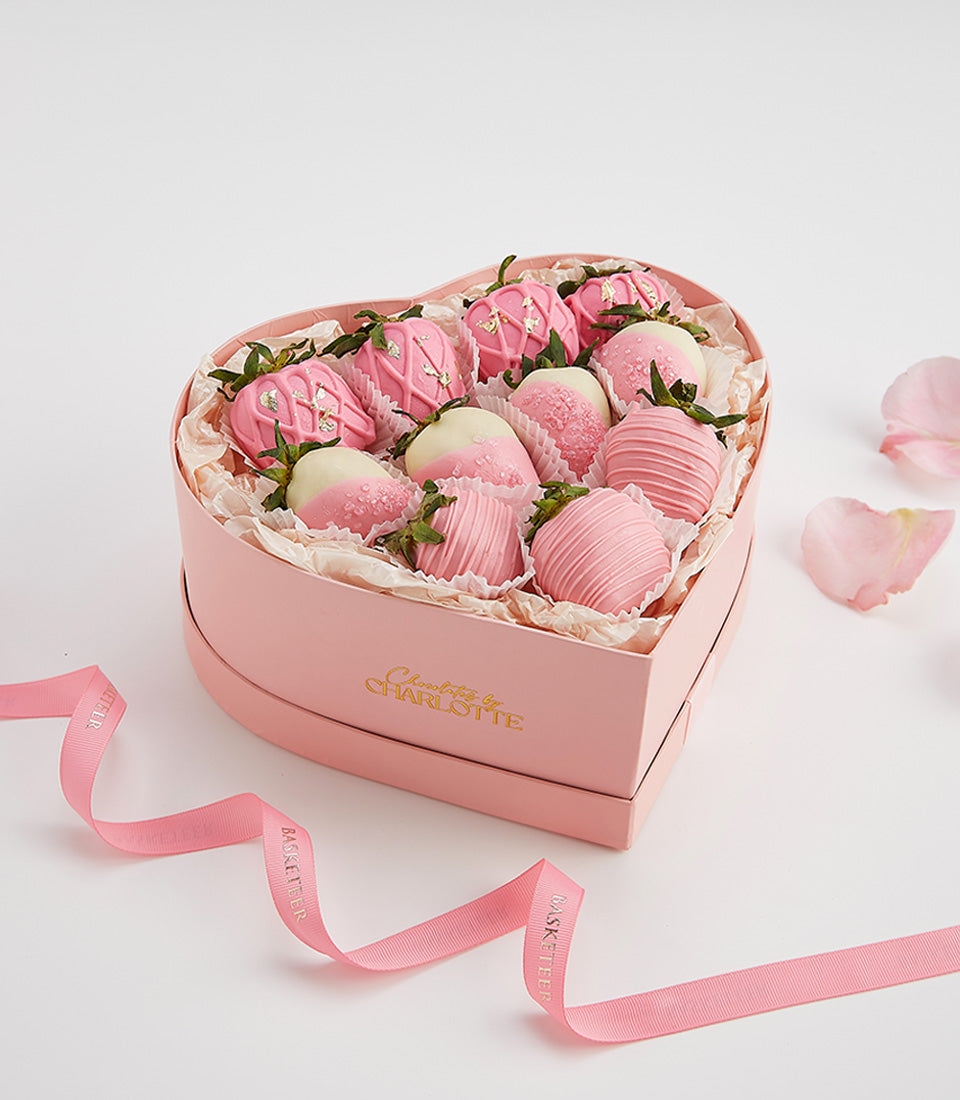 Pink heart-shaped box of chocolate-covered strawberries with rose petals, Valentine's Day gift