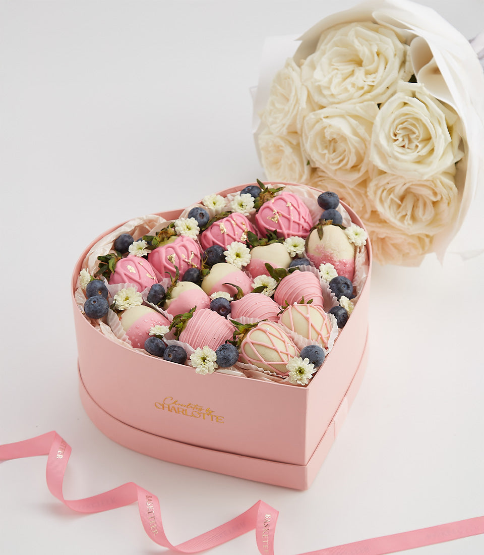 Heart-shaped chocolate-covered strawberries with blueberries and white roses Valentine's gift